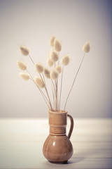 Vase of dried soft autumn flowers. Rabbit Tail Grass. vintage