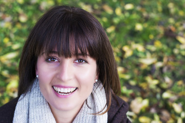 Happy woman smiling in autumn background