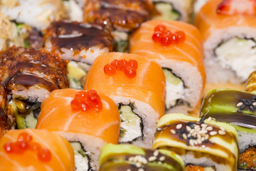 Japanese rolls in a restaurant with fish and vegetables
