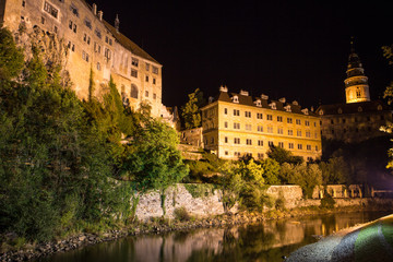 Fototapeta premium View at a castle in Cesky Krumlov during the nighttime.