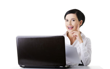 Happy businesswoman using laptop