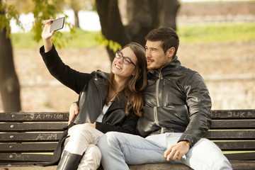 Happy Couple Taking a Selfie Photo With Mobile Phone Outdoor