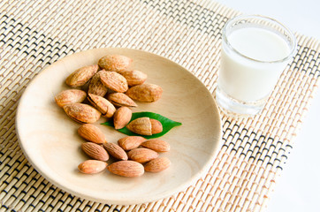 almonds milk with almonds on dish.