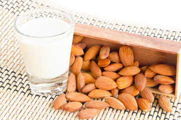 Almond milk in glass with almonds.