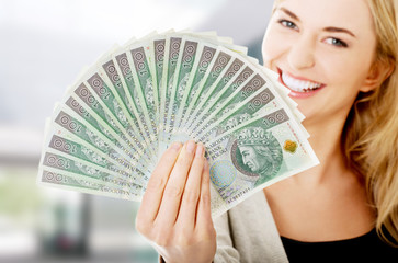 Woman holding a clip of polish money - obrazy, fototapety, plakaty