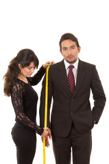 young woman tailor designer taking measures of client