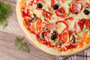 Pizza with ham, mushrooms and olives