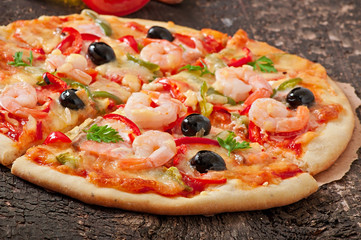 Pizza with shrimp, salmon and olives
