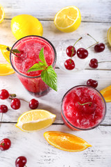 Fresh cold cherry cocktail with mint, ice and lemon