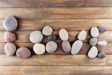 Inscription LOVE made of pebbles on wooden background