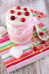 Raspberry milk dessert in glass jar,
