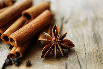 Cinnamon on wooden background, close-up