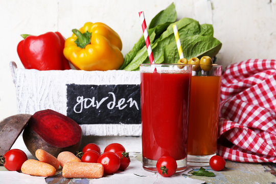 Vegetable juice and fresh vegetables in wooden box