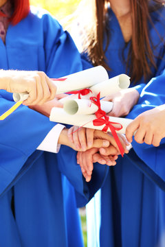 Graduate students with diplomas, close-up