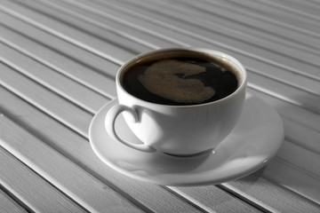 Cup of coffee on wooden table