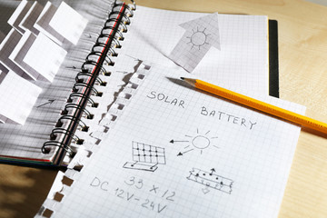 Applique paper with building and solar panels in notebook