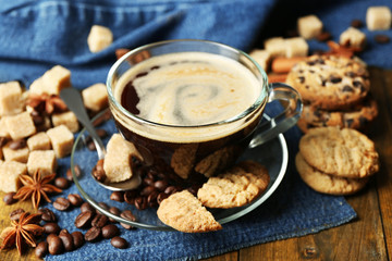 Cup of coffee and chocolate chip cookies on wooden background