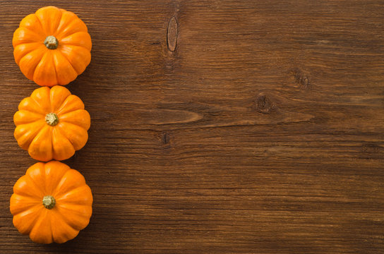 Autumn pumpkins on wooden board