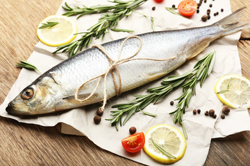 Fresh raw fish and food ingredients on table