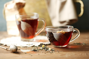 Beautiful vintage composition with herbal tea, on wooden table