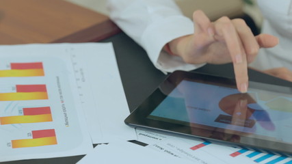 Girl in the office considers important documents on the table - Powered by Adobe