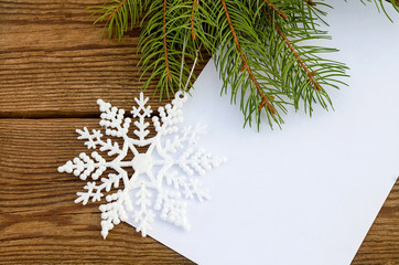 Christmas card with a sheet of paper and a snowflake