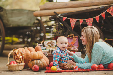Fototapeta premium Mother and son playing in the yard of his house in the village