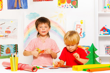 Fototapeta premium Boys making decorations and cutting carton