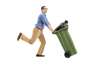 An excited man pushing a garbage can