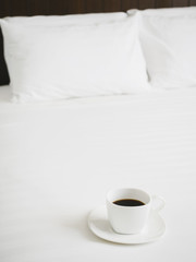 Fototapeta na wymiar Coffee on bed and pillow