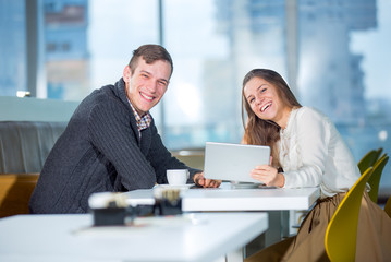 Fototapeta na wymiar Flirting couple in cafe using digital tablet, selective focus