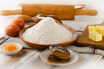 Baking ingredients  on a  white wooden background