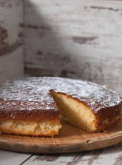 Sponge cake of lemon over wooden background