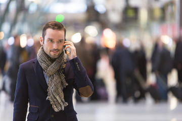 Young attractive man transiting a railway station