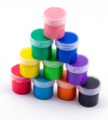 jars with colored paint on a white background