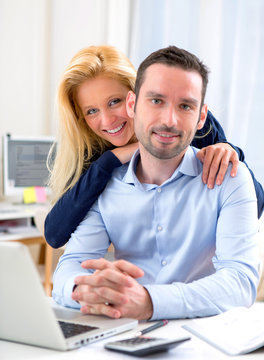Portrait of Young attractive couple using laptop