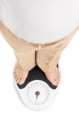 Shot of a man standing on a weight scale