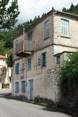 Mediterranean house painted white with blue window shutters