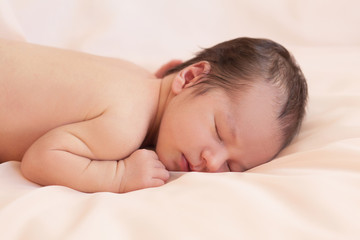 Obraz na płótnie Canvas Newborn on beige background