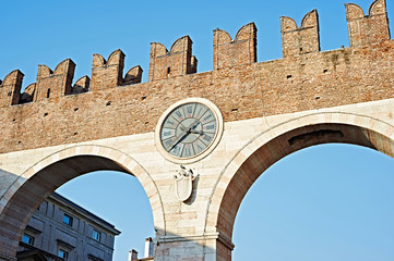 The city wall with a clock in Verona