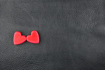 Obraz premium The concept of two lovers hearts lying on the natural leather