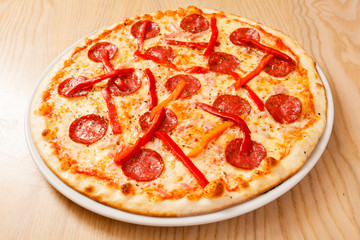 salami pizza on a wooden table