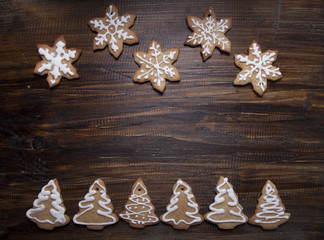 Christmas background with cookies decorated with icing , on a wo