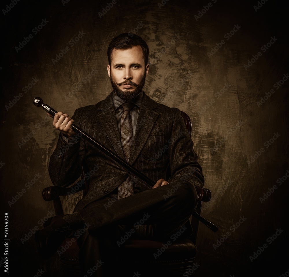 Wall mural handsome well-dressed man with walking stick