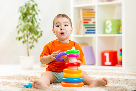 funny child playing with color toy indoor