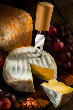 various types of cheese with grapes and nuts