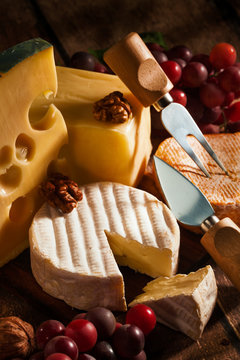 various types of cheese with grapes and nuts