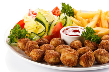 Roast meatballs, French fries and vegetable salad