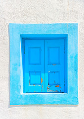 blue window of an old house in Pserimos island in Greece
