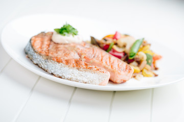 Grilled Salmon with Fresh vegetables on white background